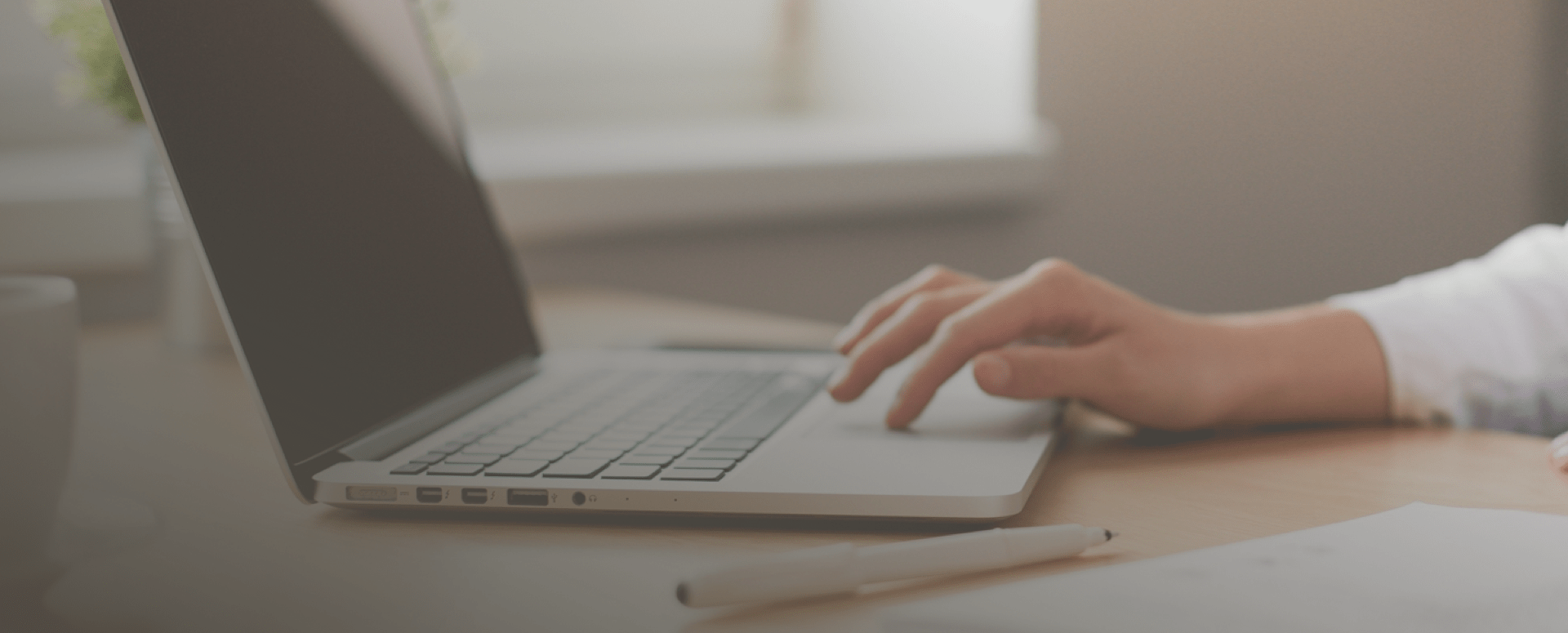 Close-up of a person’s hands typing on a laptop